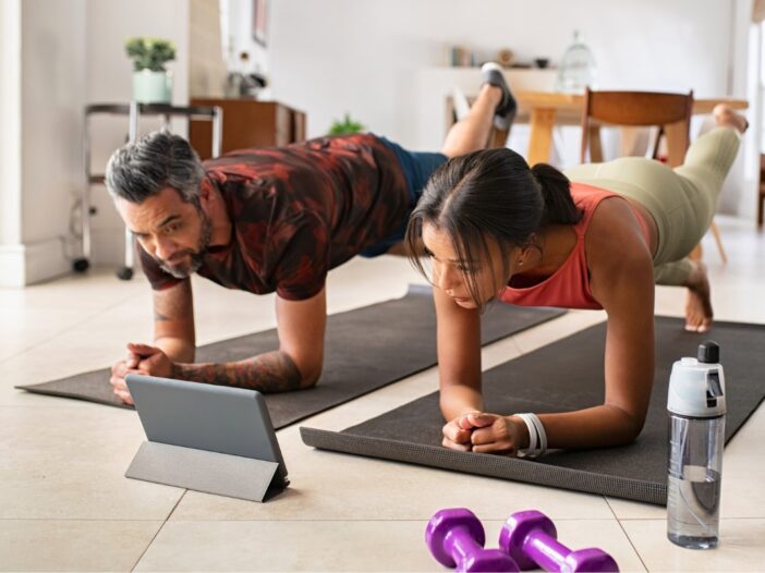 man en vrouw doen een plank oefening op een sportmatje