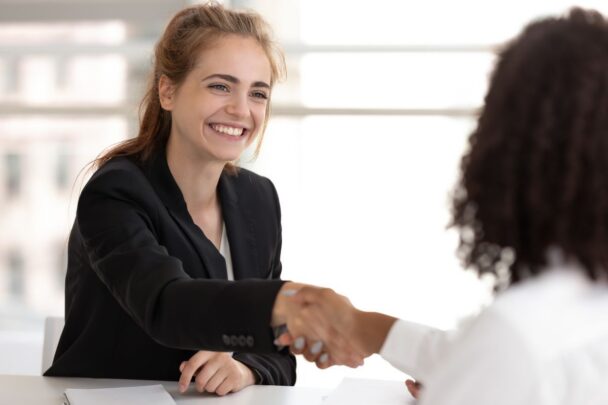 Twee vrouwen geven elkaar een hand