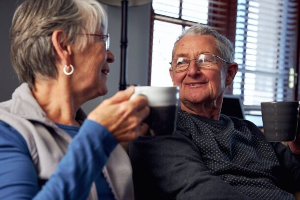 Oudere man en vrouw drinken samen een kopje koffie